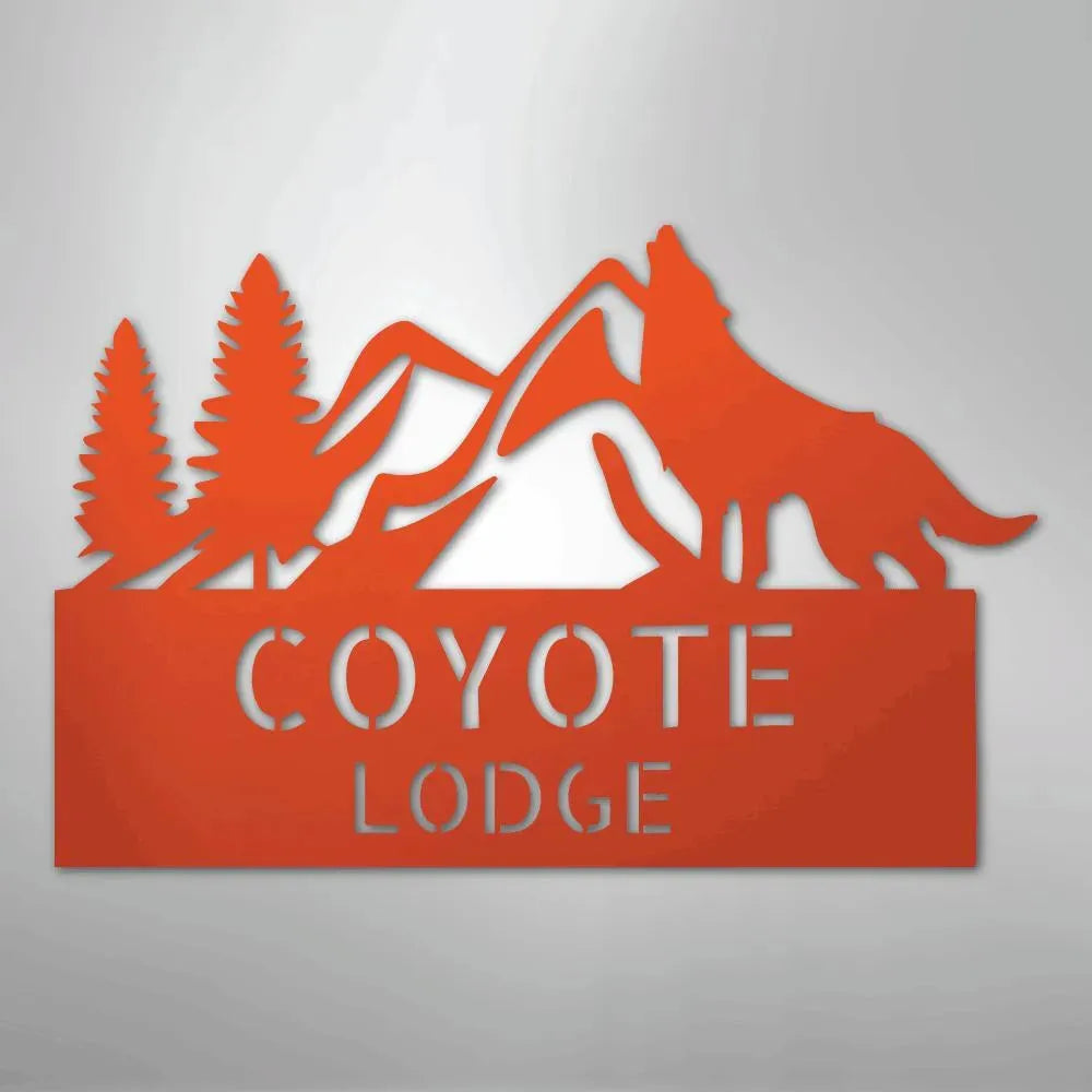 Orange metal wall art featuring a howling coyote on a mountain with pine trees, above "COYOTE LODGE.