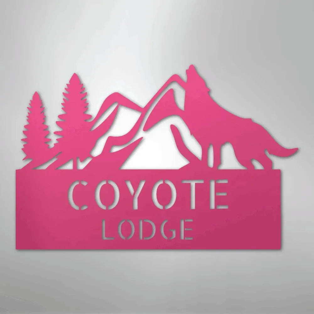 Pink metal wall art featuring mountains, pine trees, a howling wolf, and "COYOTE LODGE" text.