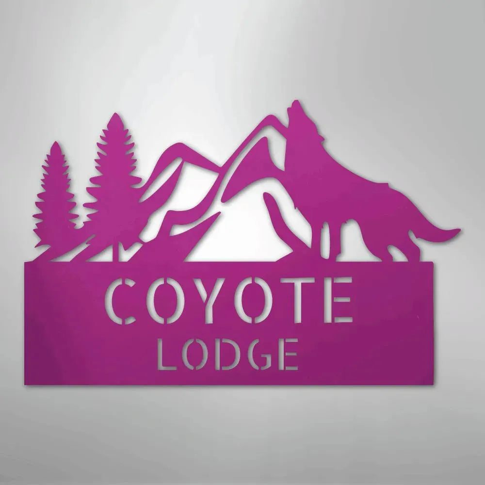 Pink metal wall art featuring mountains, pine trees, and a howling wolf above "COYOTE LODGE.
