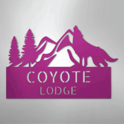 Pink metal wall art featuring mountains, pine trees, and a howling wolf above "COYOTE LODGE.