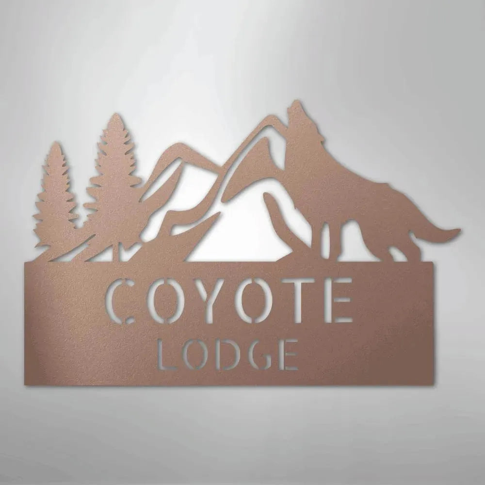 Rose gold metal wall art featuring mountains, pine trees, a howling wolf, and "COYOTE LODGE" text.