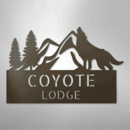 Brown metal wall art featuring a howling wolf, mountains, pine trees, and "COYOTE LODGE" text.