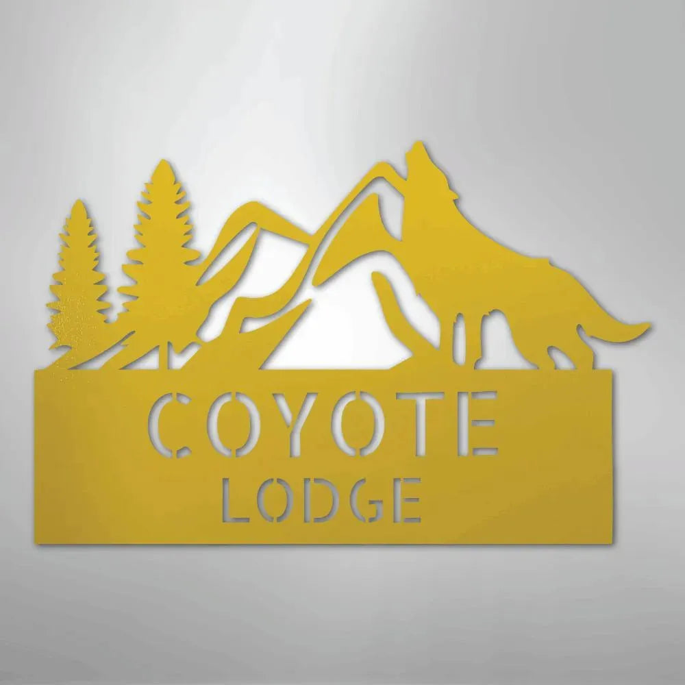 Yellow metal wall art featuring a howling coyote, mountains, pine trees, and "COYOTE LODGE" text.