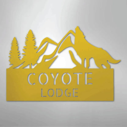 Yellow metal wall art featuring a howling coyote, mountains, pine trees, and "COYOTE LODGE" text.