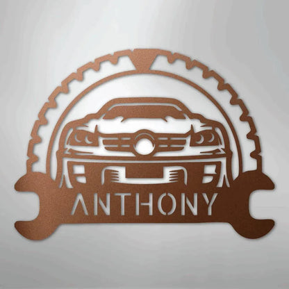 Copper metal car monogram with a gear and wrench design, customizable with a name like "ANTHONY".