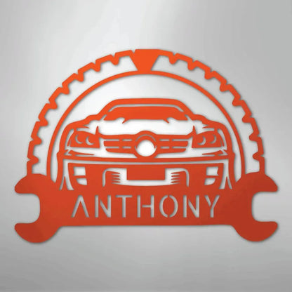 Orange metal classic car monogram with custom name "ANTHONY" and wrench/gear design.