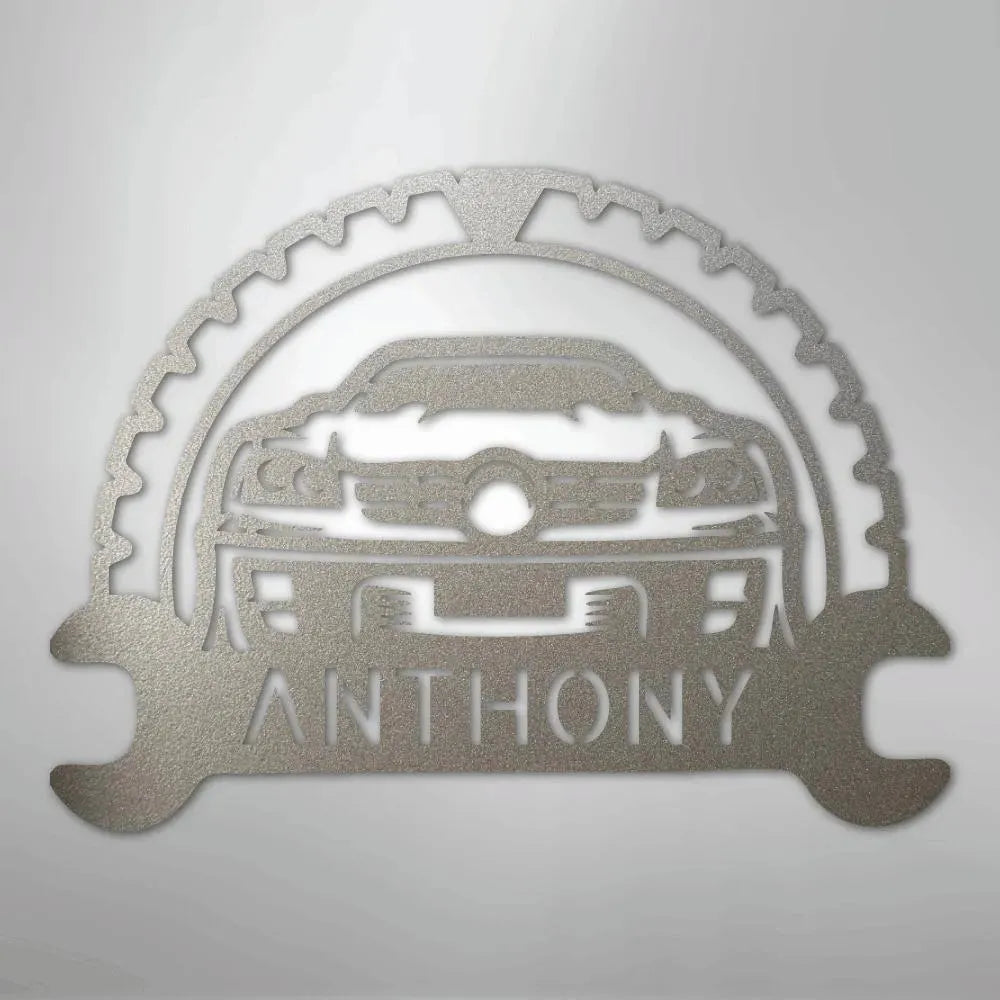 Silver metal custom car monogram wall art with "ANTHONY" text, gear, and wrench details.