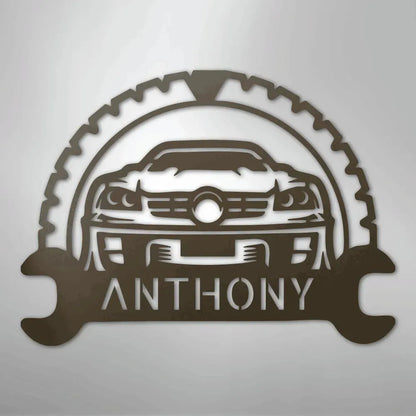 Brown metal classic car monogram with "ANTHONY" text, gear, and wrench details.