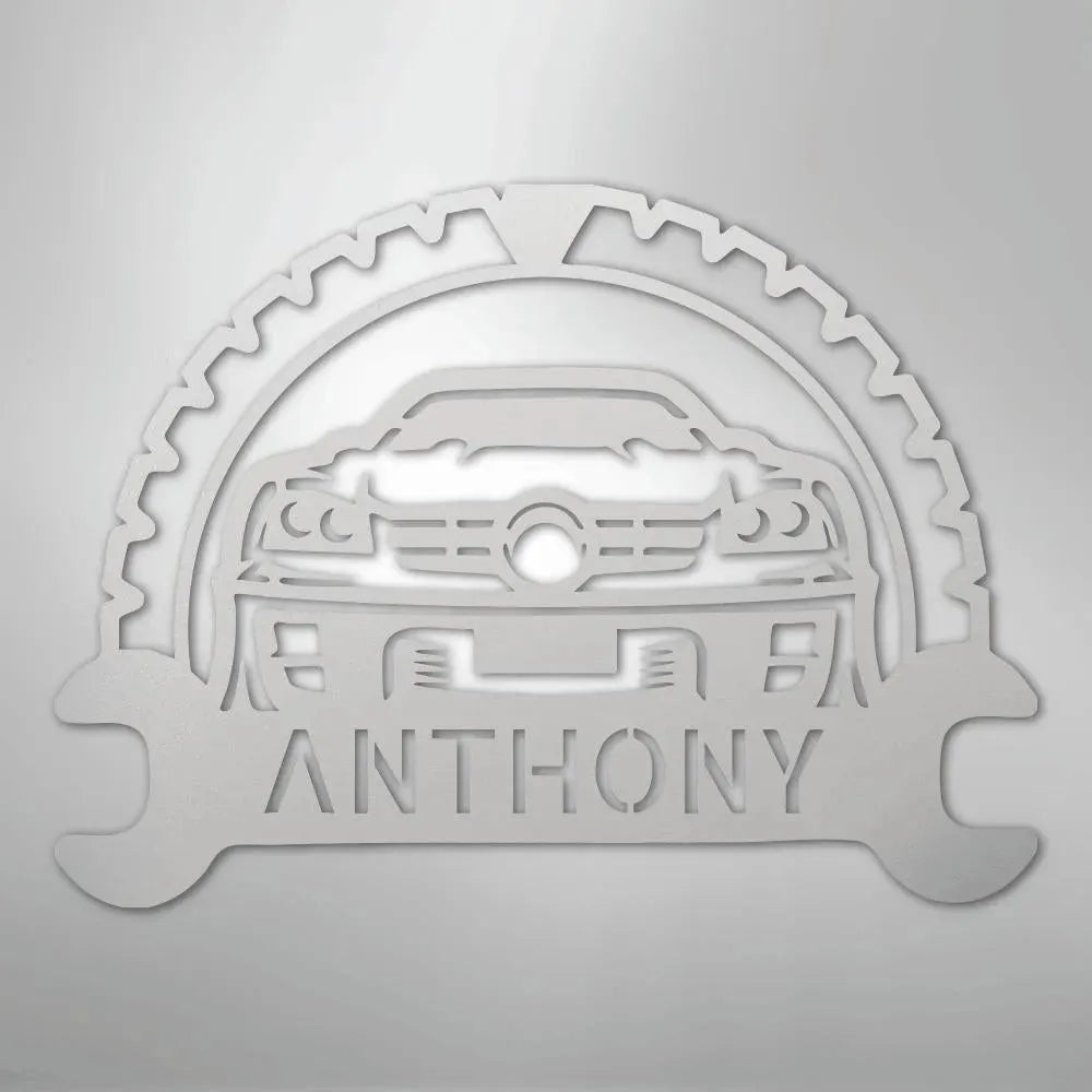 Silver metal classic car monogram with "ANTHONY" text, gear, and wrenches.