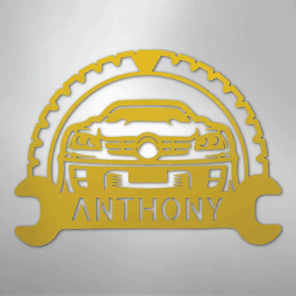 Yellow metal classic car monogram with custom name "ANTHONY" and gear/wrench design.