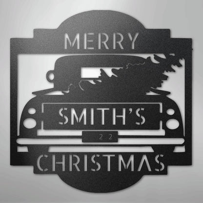 Black metal Christmas truck monogram with "MERRY SMITH'S 22 CHRISTMAS" cut out, featuring a tree.