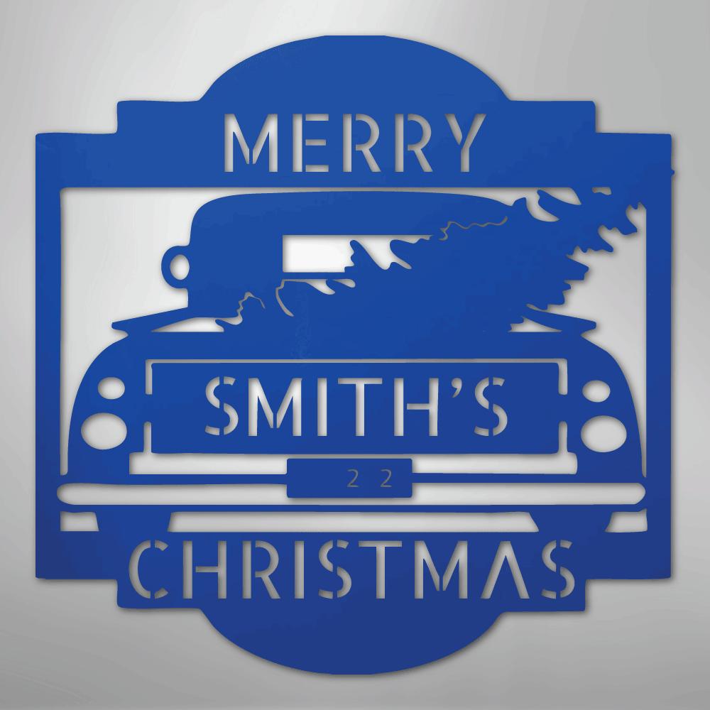 Blue metal Christmas truck monogram with "MERRY SMITH'S 22 CHRISTMAS" text and a tree in the truck bed.
