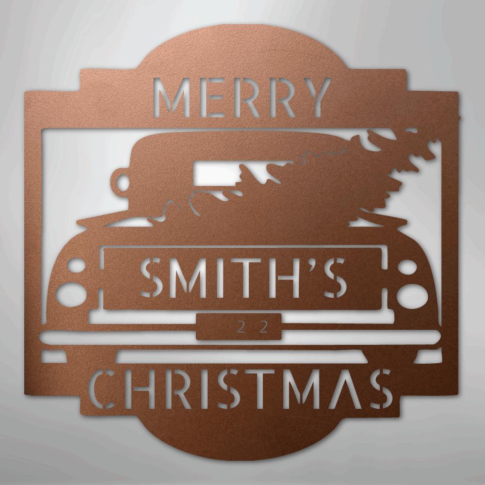Copper metal Christmas truck monogram with "MERRY SMITH'S 22 CHRISTMAS" cut out, featuring a tree.
