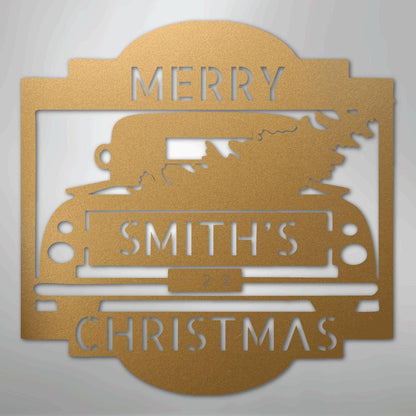 Gold metal Christmas truck monogram with "MERRY SMITH'S CHRISTMAS" and a tree in the truck bed.