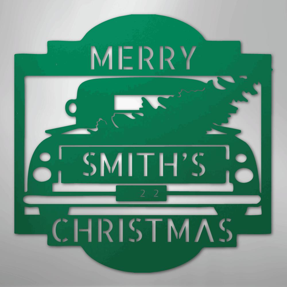 Green metal Christmas truck monogram with "SMITH'S 22 MERRY CHRISTMAS" cut out, carrying a tree.