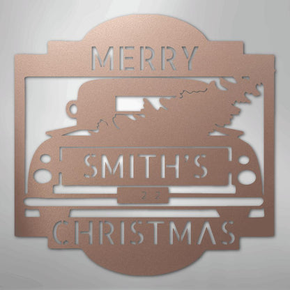 Rose gold metal Christmas truck monogram with "MERRY SMITH'S 2022 CHRISTMAS" cut out.