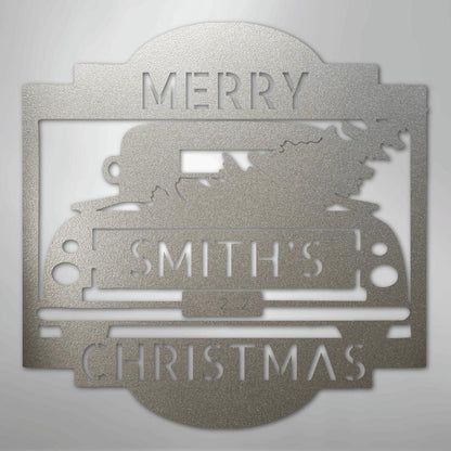 Silver metal Christmas truck monogram with "MERRY SMITH'S CHRISTMAS" cut out, featuring a tree in the truck bed.