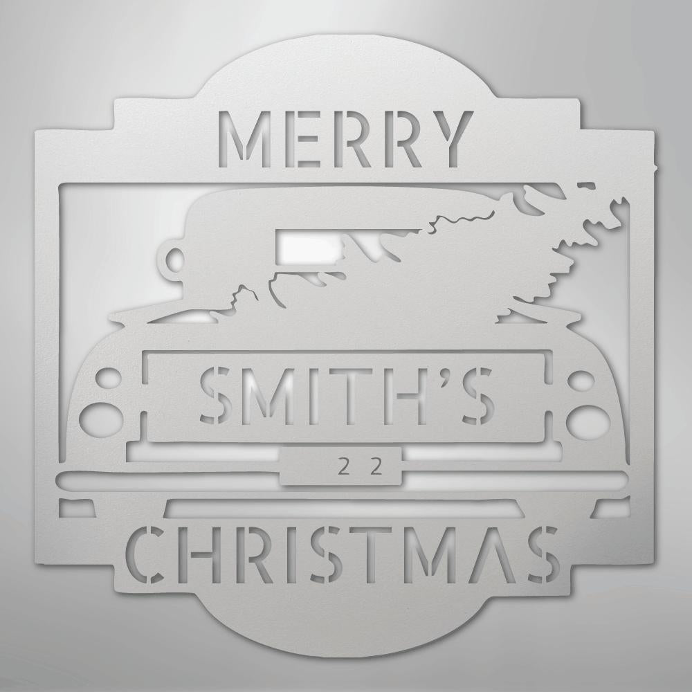 White metal Christmas truck monogram with "MERRY SMITH'S 22 CHRISTMAS" cut out, featuring a tree in the truck bed.