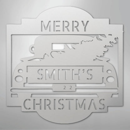 White metal Christmas truck monogram with "MERRY SMITH'S 22 CHRISTMAS" cut out, featuring a tree in the truck bed.