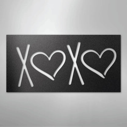 Black metal wall art with "XOXO" design, featuring two hearts, for indoor or outdoor decor.