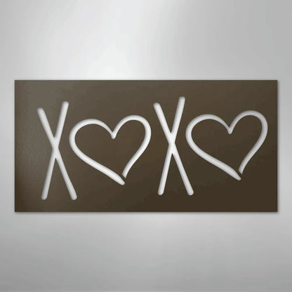 Brown metal XOXO wall art with cutout white letters and hearts.