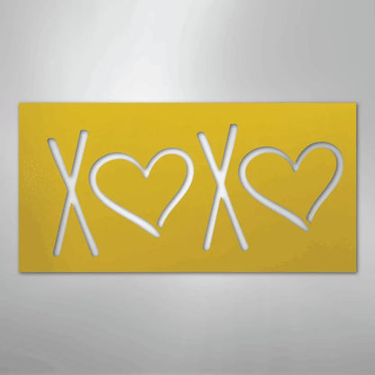 Yellow rectangular metal wall art featuring cutouts of "XOXO" with hearts, suitable for indoor/outdoor decor.