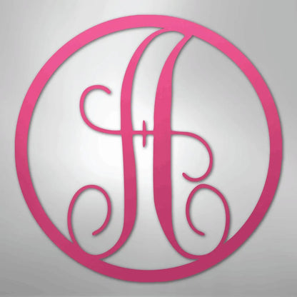 Pink metal wall art with a fancy initial "A" in a decorative circle monogram.