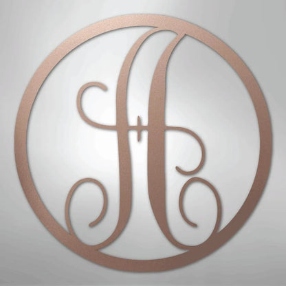 Copper metal wall art with a fancy script initial "H" inside a circular frame.