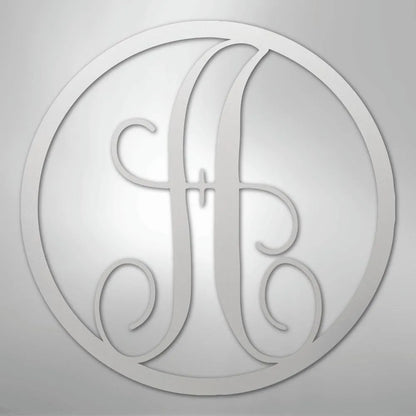 Silver metal wall art with a fancy script initial "A" inside a circular frame.