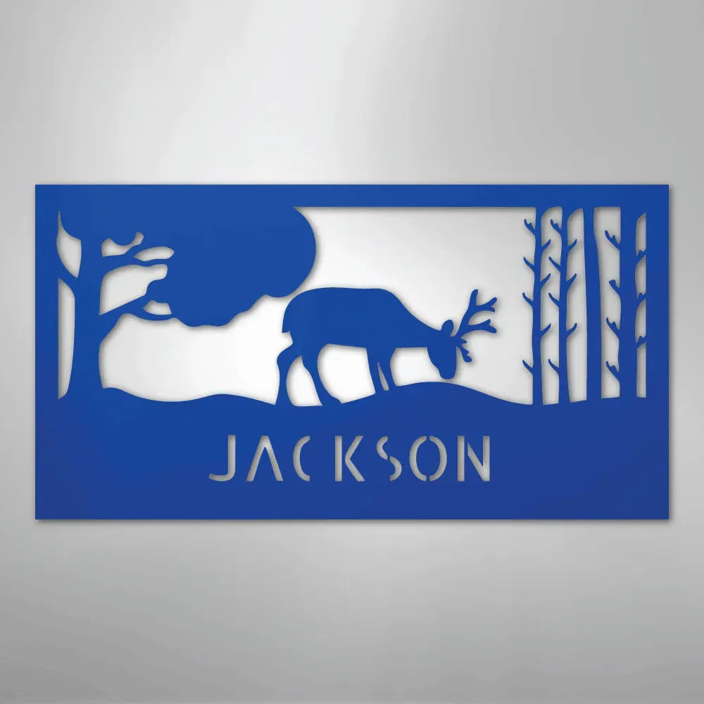 Blue metal wall art featuring a grazing deer, trees, and "JACKSON" cut out below.