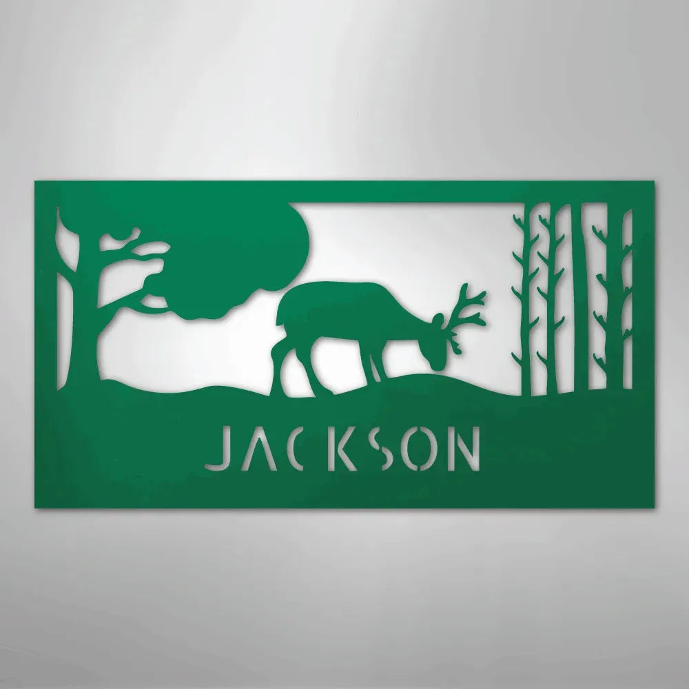 Green metal wall art featuring a grazing deer, trees, and "JACKSON" cutout below.