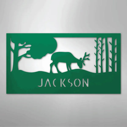 Green metal wall art featuring a grazing deer, trees, and "JACKSON" cutout below.