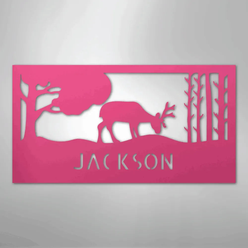 Pink metal wall art featuring a grazing deer, trees, and "JACKSON" cutout.