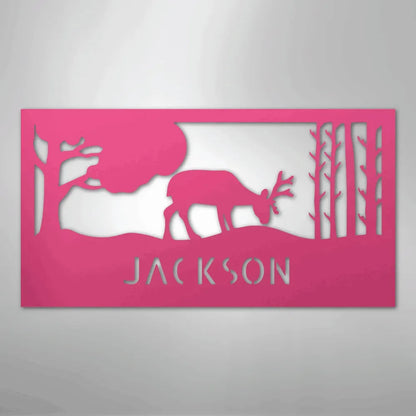 Pink metal wall art featuring a grazing deer, trees, and "JACKSON" cutout.
