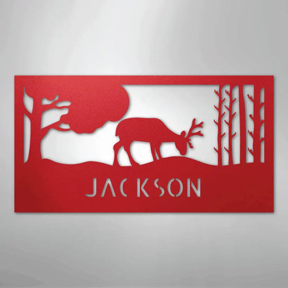 Red metal wall art featuring a grazing deer, trees, and "JACKSON" personalized monogram.