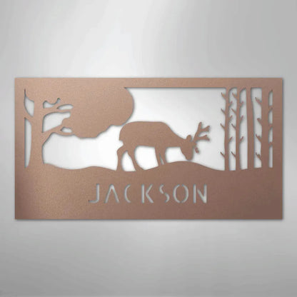 Copper metal wall art with a grazing deer, trees, and "JACKSON" custom monogram.