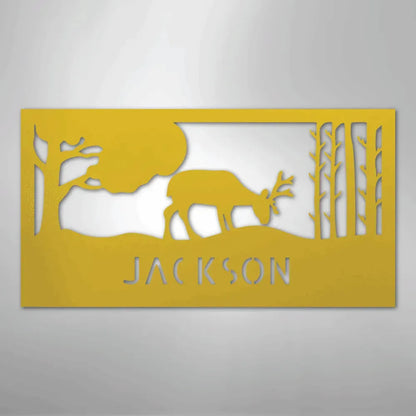 Yellow metal wall art featuring a grazing deer, trees, and "JACKSON" cut out below.