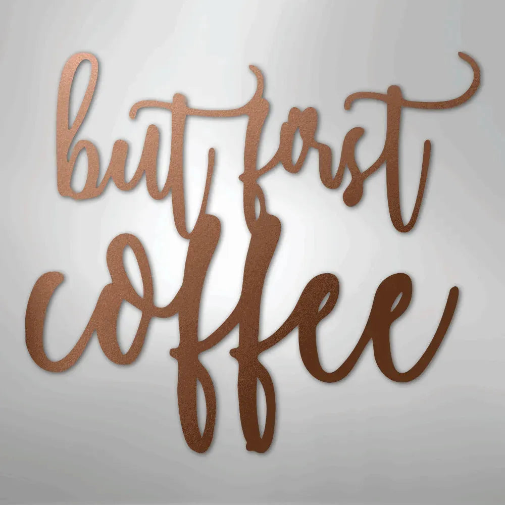 Copper metal wall art with "but first coffee" in elegant script.