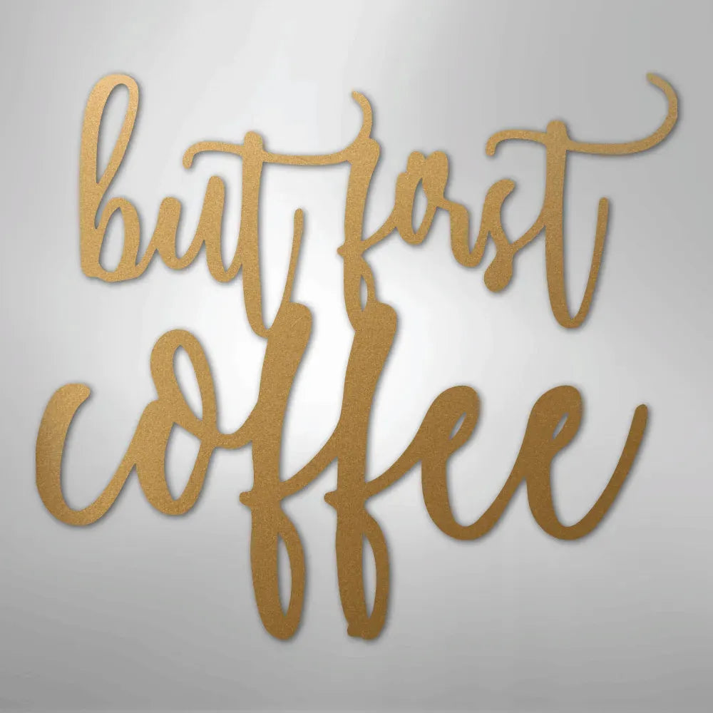 Gold metal wall art decor with "but first coffee" in elegant script.