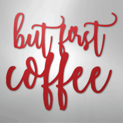Red "but first coffee" metal wall art in a decorative script font.