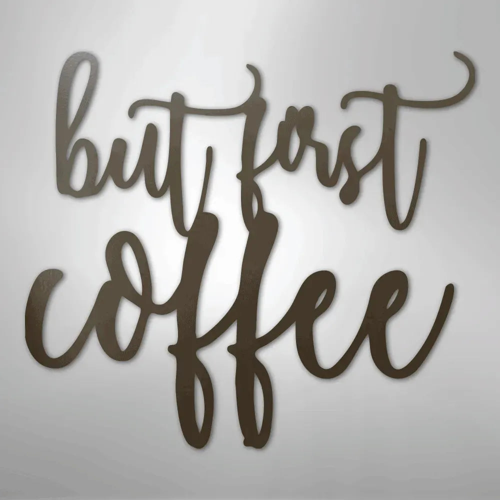 Brown metal wall art with "but first coffee" in elegant script.