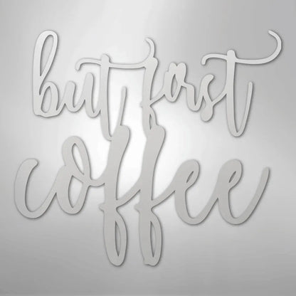 Silver metal wall art with "but first coffee" in elegant script.