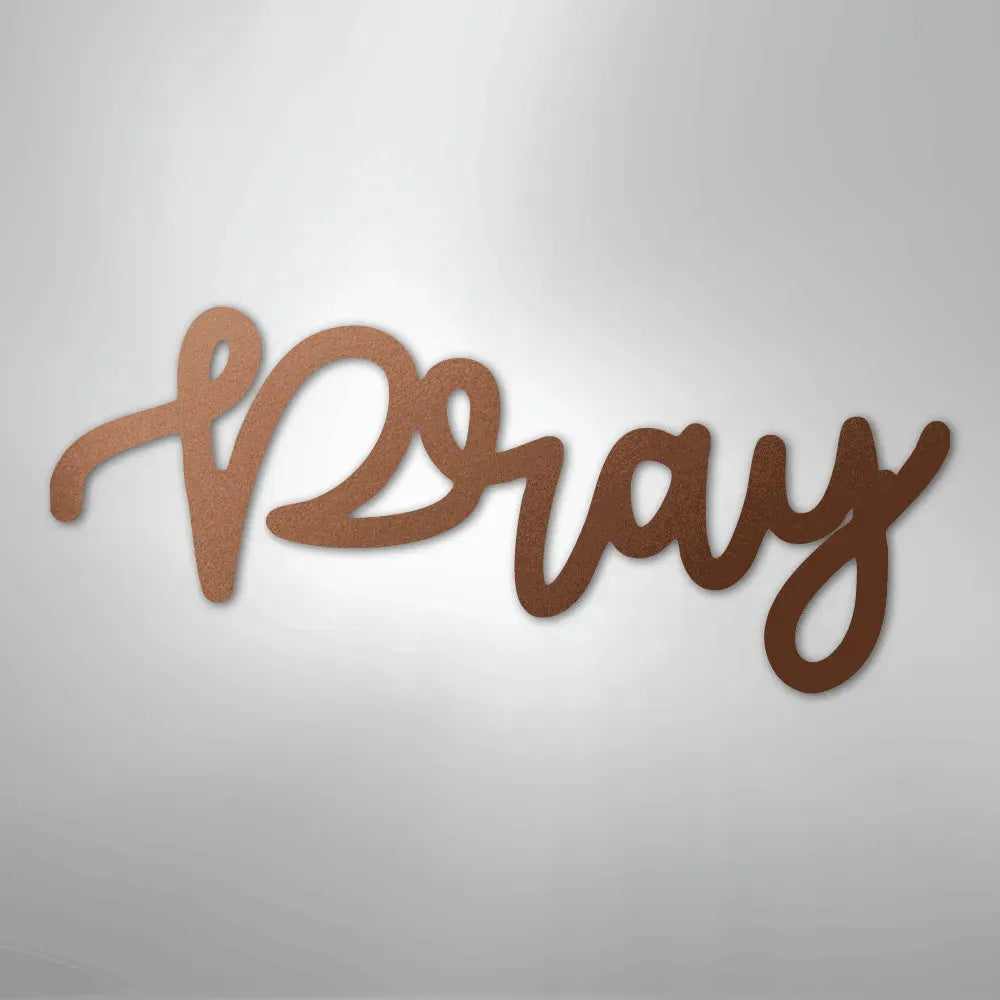 Copper "Pray" script metal wall art with a handwritten font, casting a subtle shadow on a light background.