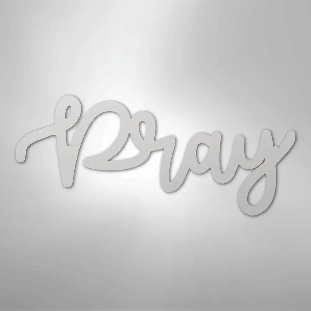 White metal "Pray" script wall art in a flowing, elegant font.