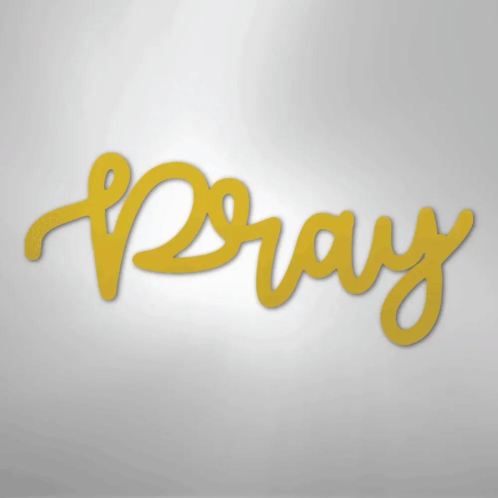 Gold "Pray" script metal wall art in a flowing, handwritten style, casting a subtle shadow.