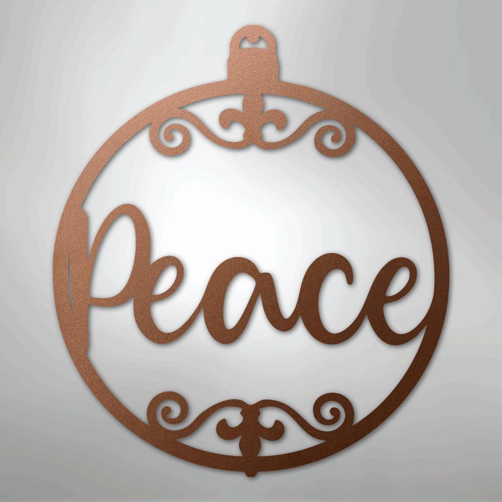Copper-colored metal wall art shaped like a Christmas ornament with "Peace" in script and decorative flourishes.