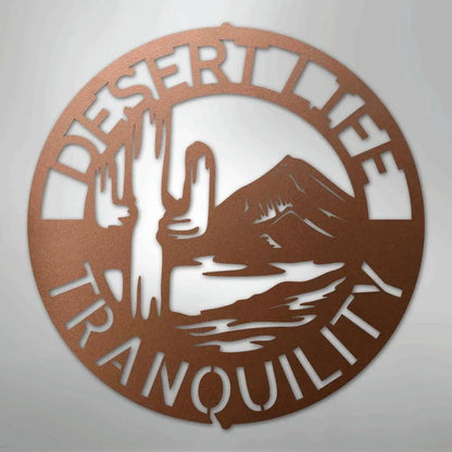 Copper metal wall art with "Desert Life Tranquility" text, saguaro cactus, and mountain design.