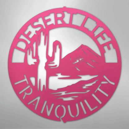 Pink metal wall art: "Desert Life Tranquility" monogram with cactus and mountain silhouette.