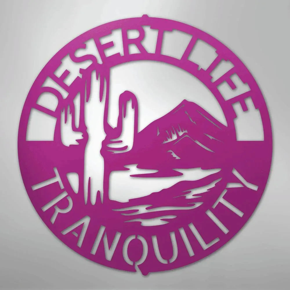 Pink metal wall art: "Desert Life Tranquility" monogram with saguaro cactus and mountain.