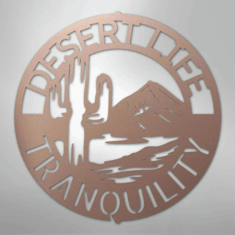Round copper metal wall art with "DESERT LIFE TRANQUILITY" text, saguaro cactus, and mountains.